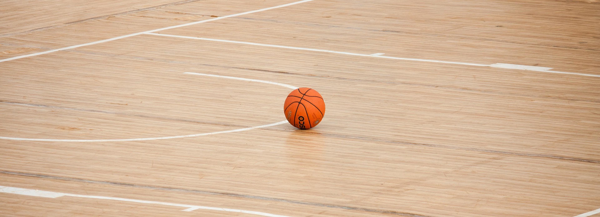 basketball on hardwood floor gym